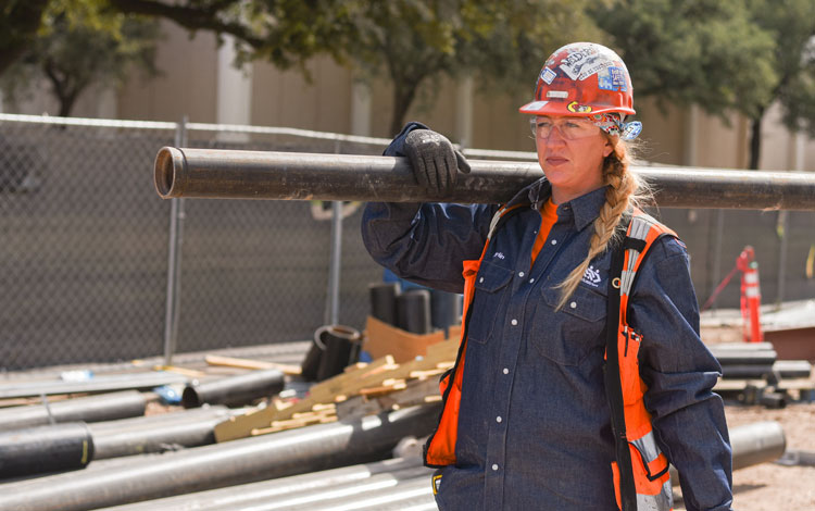 Kaylin Leas carrying a pipe.